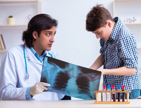 Male radiologist looking at boy's images