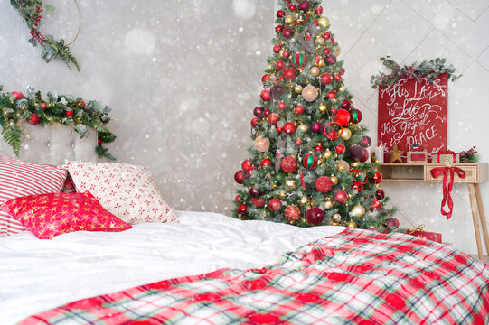 Christmas themed decorated room in light colors with bad and Christmas tree. postcard, background. Christmas themed photo zone in studio