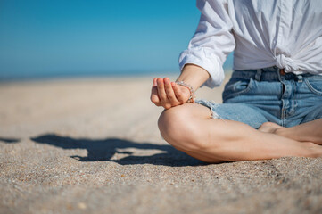 Girl practice meditation on the beach. With space for text or design