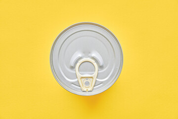 Round canned food on yellow background.