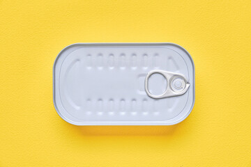 Square canned food on a yellow background.