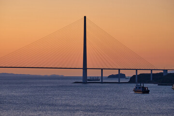 Suspended cable-stayed bridge from the mainland of the Far Eastern city to the Russian Island. The...