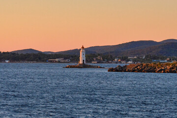 Fototapeta na wymiar Tokarevsky lighthouse on the background of the sea. Vladivostok, Russia.
