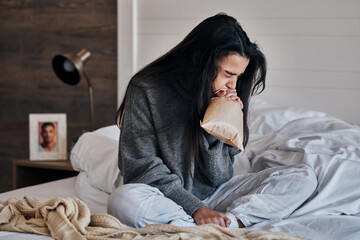 Woman, anxiety and paper bag stress breathing on bed in house or home bedroom in divorce crisis,...