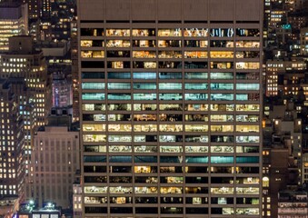 Fototapeta na wymiar Office windows illuminated at night