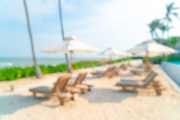 abstract blur umbrella with beach chair for background