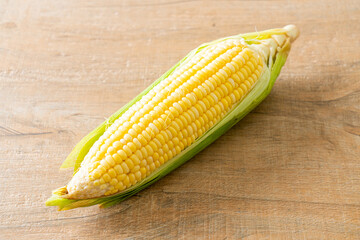 fresh corn on wood background