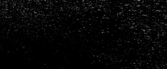 Abstract glitter background, snow imitation in silver, on black, white scratches isolated on a black background. template for design.