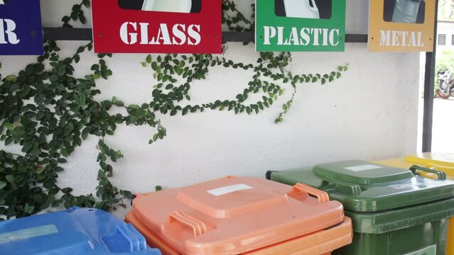Empty bottle. Plastic garbage bin trash container. Hand bottle into recycle bin.