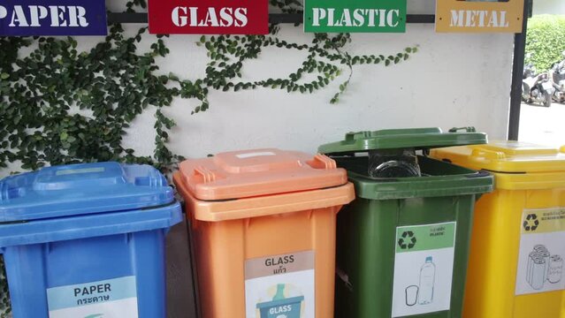 Empty bottle. Plastic garbage bin trash container. Hand bottle into recycle bin.