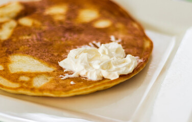 Close up shot of a home made pancake on the plate. Food