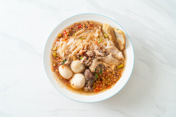 noodles with pork and meatballs in spicy soup