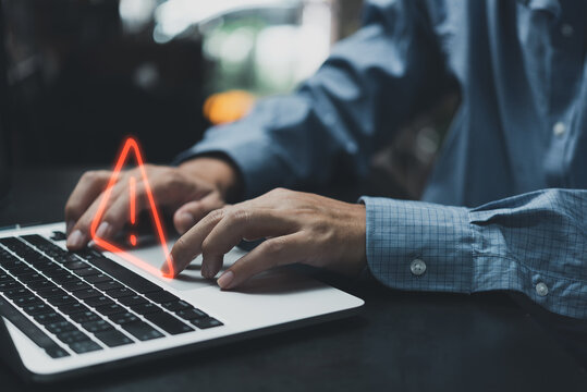 Businessman Programmer, Developer Using Laptop Computer With Triangle Caution Warning Sign For Notification Error And Maintenance Concept.