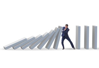 Businessman preventing domino effect in business concept