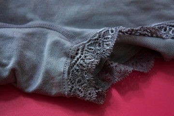 Gray floral lace luxury elegant women short-body shapewear panty on pink background. 