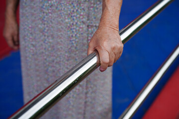 Asian elderly old woman patient use support rail on ramp, handrail safety grab bar, security in nursing hospital.