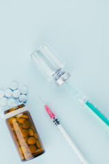 syringe with needle, vial and pills. illegal doping in sport concept, flu vaccine, aesthetic...