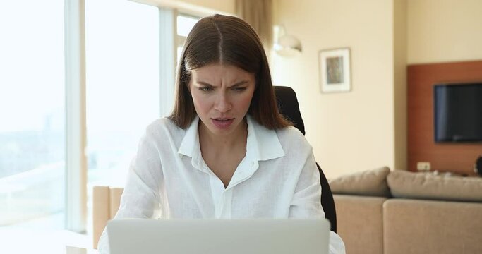 Pretty young laptop user woman getting unexpected problems with computer, software error, app wrong work, finding mistake, receiving bad news notification, feeling stressed, frustrated