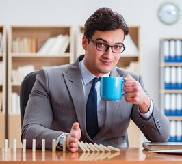 Businessman with dominoes in the office