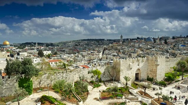 Time lapse of Damascus Gate and old Jerusalem City. People walk in the park entering the old city of Jerusalem through the Damascus Gate