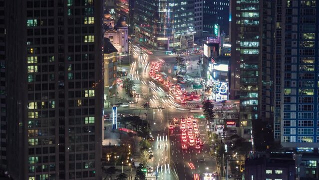 City traffic lights at night time in Seoul, South Korea. Evening Seoul - skyscrapers, cars and traffic. Time lapse. Busy city in rush hour. 4K, UHD