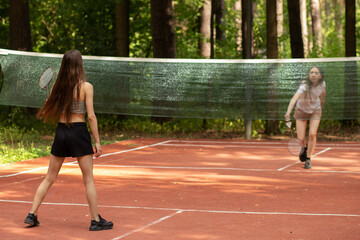 badminton players playing with badminton rackets in the park