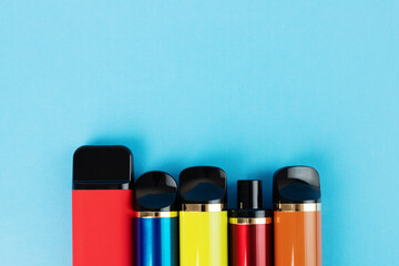 vape, disposable liquid vaporizers on a blue background, copy space
