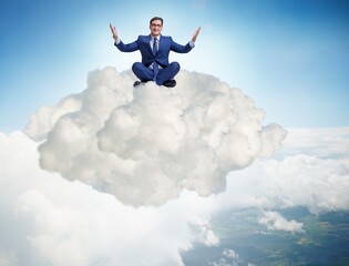 Businessman sitting at top cloud