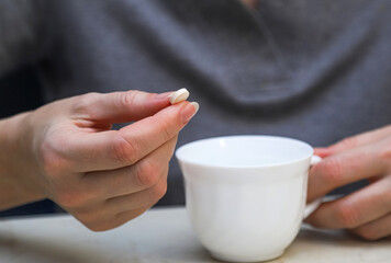 The middle-aged woman taking a pill