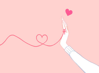 運命の赤い糸を結んでいる女性の手