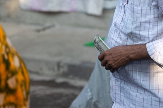 Hand of a man holding Indian currency note of Rs. 500. Economy, market, cash, count, shop, owner, buy, sell, digital payment, demonetization, bargain, epf, ppf, savings, investment, fund, bank, rd, fd