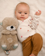 a baby with a bear toy