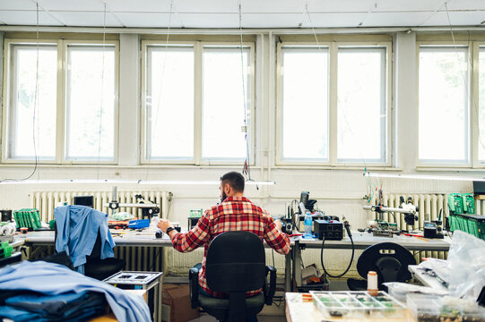 Electronics engineer working in a workshop with tin soldering parts