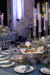 table setting in a restaurant with decor and candlesticks