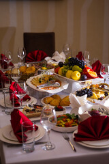 the table in the room is set in red tones with food for the holiday