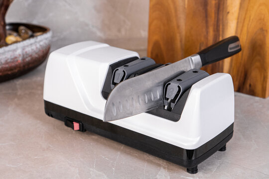 Electric Knife Sharpener On The Kitchen Table