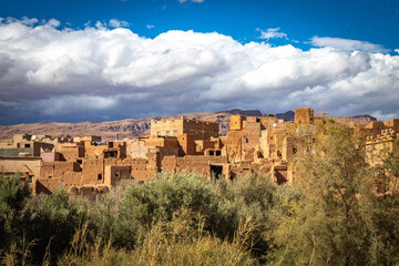 Fototapeta premium kasbah, valley of roses, morocco, oasis, river, m'goun, high atlas mountains, north africa, dramatic sky