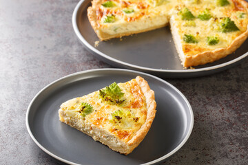 Cheese and Romanesco cabbage quiche tart closeup on the plate on the table. Horizontal