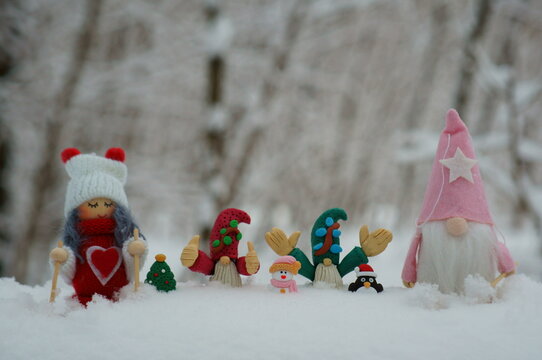 Christmas toys in the winter forest. Santa, angel, gnomes, penguin, snowman. Christmas decorations for the new year.