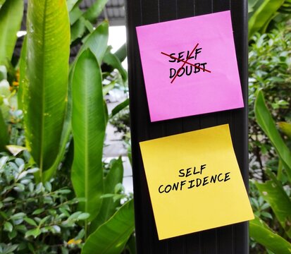 Pink and yellow notes with text SELF DOUBT - SELF CONFIDENCE, concept of to overcome SELF DOUBT from keeping you struck, get out of fear and regaining self-confidence