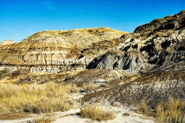 The rugged steep hills of the badlands of southern Alberta on a bright autumn day.