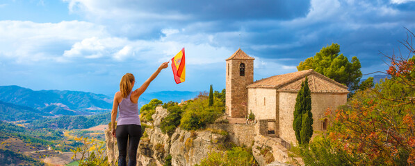 Hiker woman tourist in Catalonia,  Siurana in Spain- Spain flag