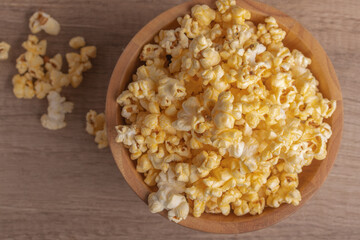 Popcorn in a wooden cup. Snacks.