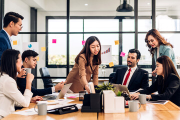 Group of asian business meeting and discussing strategy startup project analysis finance process.Success business people work plan and brainstorm marketing idea with laptop in office.Teamwork