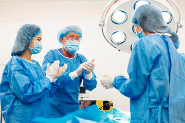 Professional anesthesiologist doctor medical team and assistant preparing patient to gynecological...