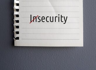 Note paper with word INSECURITY, crossing out to SECURE - to break away from negative thought cycle...