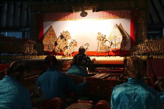 Yogyakarta, Java, Indonesia - March 6th 2018: Look over orchestra to puppeteer of wayang kulit