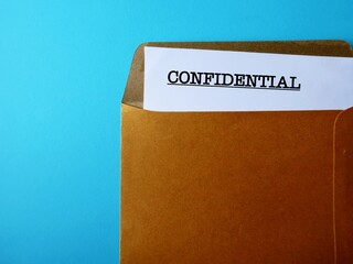 Office envelope with document typed CONFIDENTIAL, concept of data or information intended to be...