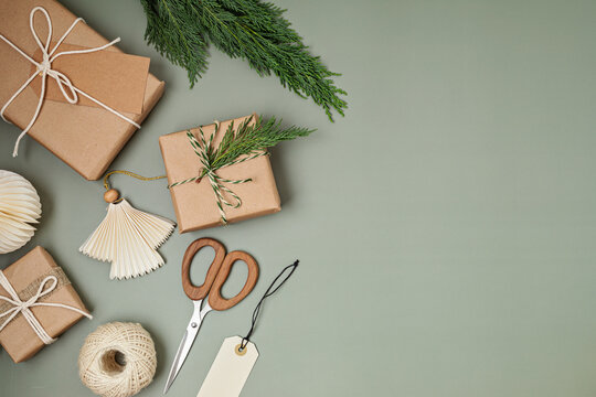 Christmas background with gift boxes and kraft wrapping paper. Xmas celebration, preparation for winter holidays. Festive mockup, top view, flatlay