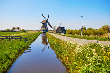 Traditional Dutch windmill on the field